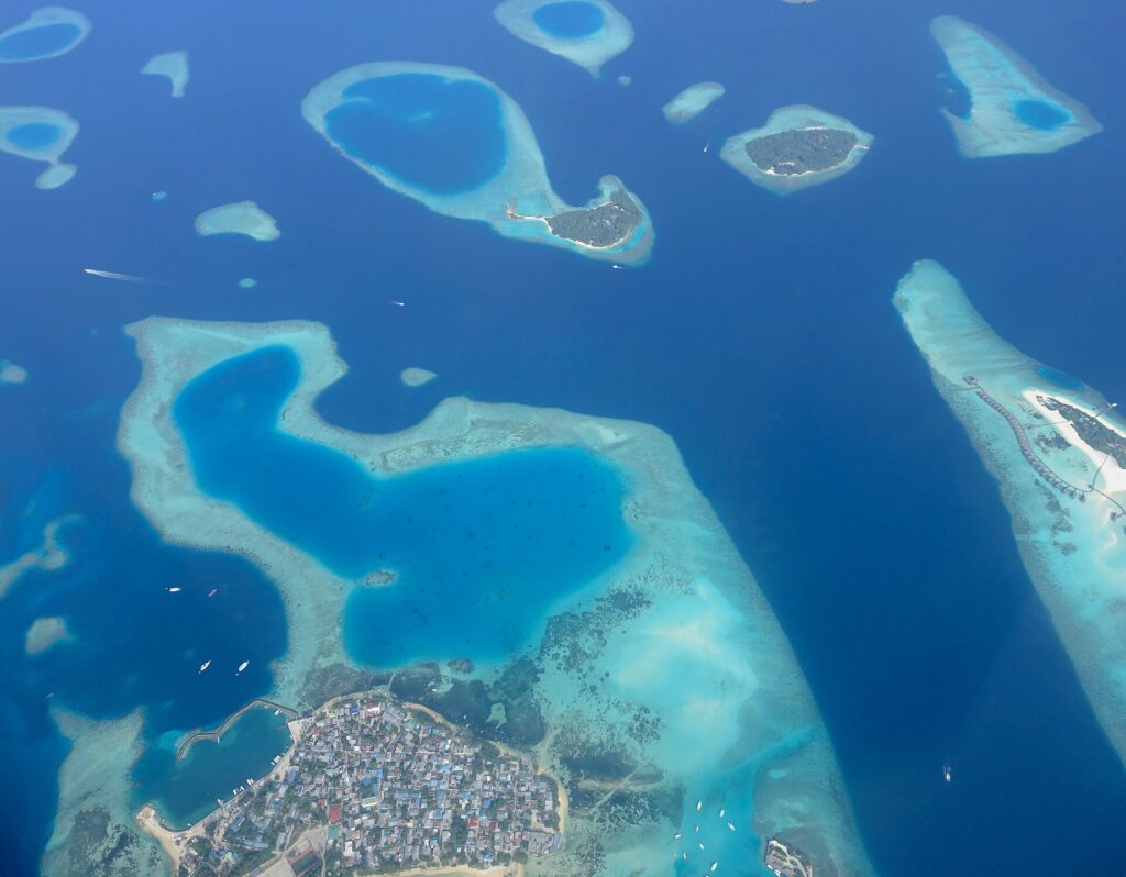 Aerial view of Guraidhoo and its surrounding reefs in South Malé Atoll