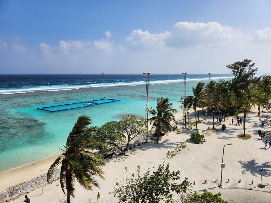 The public beach at Hulhumalé with palms and a shallow lagoon